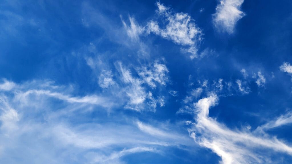 Bright blue sky with wispy clouds