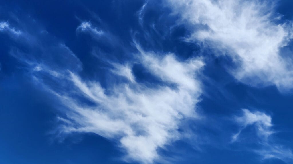 Fluffy white clouds against blue sky