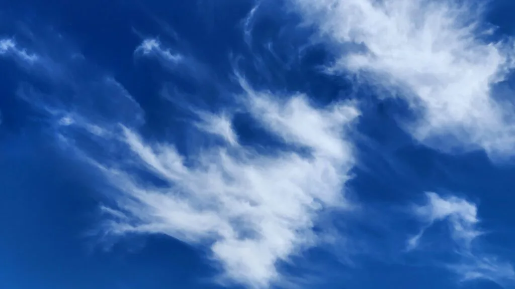 Fluffy white clouds against blue sky