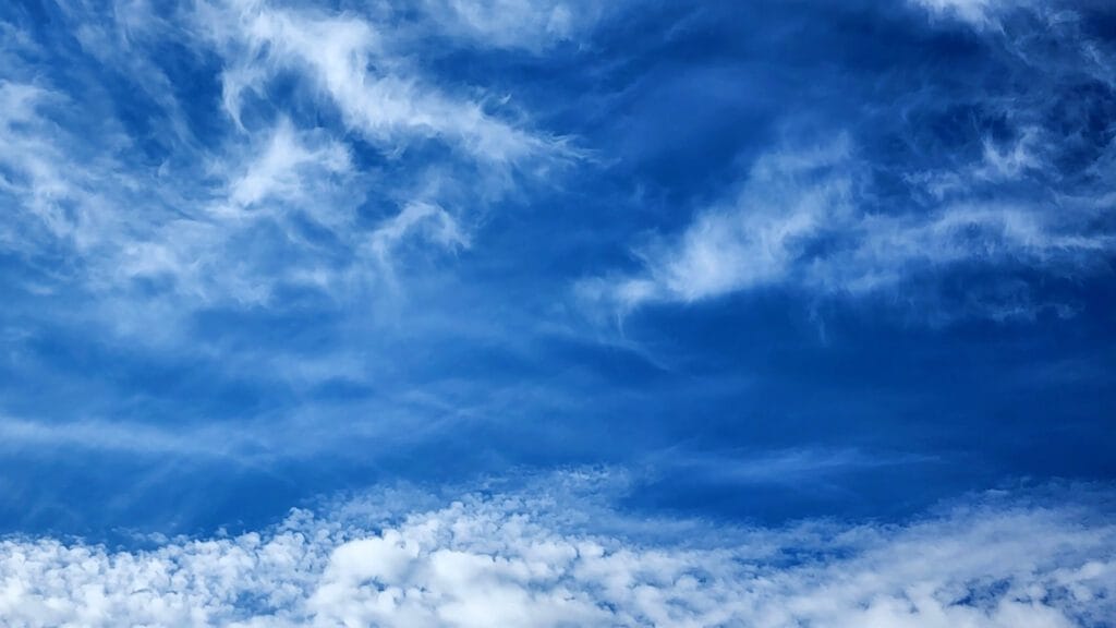 Bright blue sky with fluffy clouds